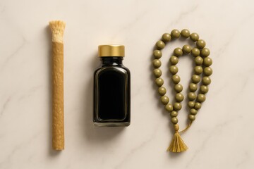 Still life featuring miswak, bottle and prayer beads on a marble surface