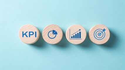 Four wooden circles with blue business icons and text K P I on a light blue background finance growth