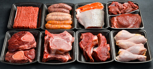 Banner. Set of raw meat and fish in plastic containers. Products from the market. Side view.