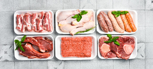 Different types of raw meat in plastic boxes packaging tray