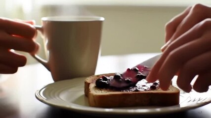 Cup of coffee and toast with jam breakfast.
Minimalist breakfast scene of hot coffee and toast with berry jam in soft morning light.
- Powered by Adobe