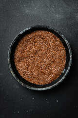 Flax seeds in a wooden bowl. Organic food, superfood. Top view.