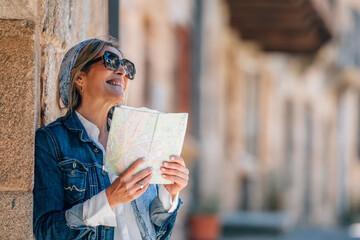 female traveler or tourist on the street with a map