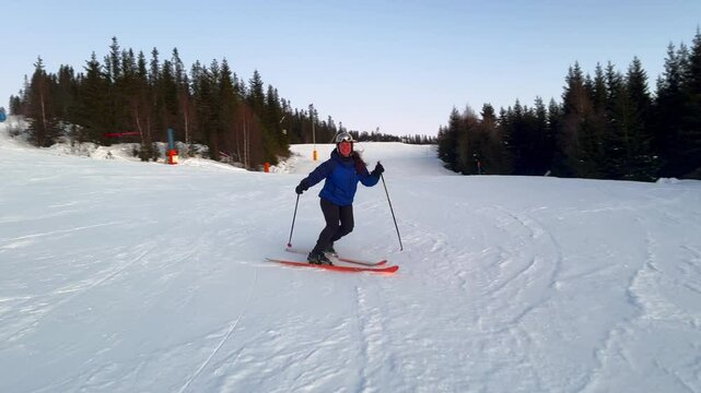 Telemark downhill skier skiing Hafjell Alpine ski resort &Oslash;yer mountain Norway Norge arctic sunset golden hour last run Olympic torch man Lillehammer clear skies groomed trail runs icy packed follow