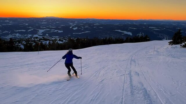 Telemark downhill skier skiing Hafjell Alpine ski resort &Oslash;yer mountain Norway Norge vibrant artic sunset golden hour Olympic torch man Lillehammer clear skies groomed trail runs icy packed follow