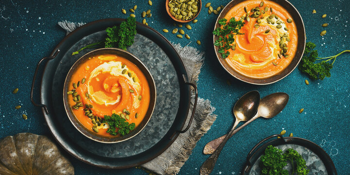 Two bowls of pumpkin soup. Pumpkin Autumn Healthy Food Nutrition Seasonal Vegetable Concept. Autumn vegetables. Top view.