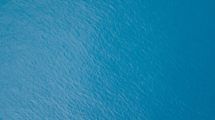 Aerial view over beautiful ocean blue waves crashing