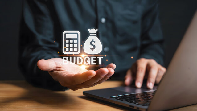 Concept of budgeting financial planning with a laptop, a man holds a calculator and money bag in his hand, symbolizing wealth and savings investments for future economic success.