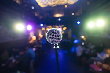 Microphone on stage against a background of auditorium.