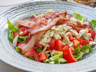 fresh salad with tomatoes, bacon, blue cheese