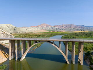 Nallihan Bird Sanctuary (Nallihan Kus Cenneti) Majestic arch bridge spans a serene river landscape. An expansive view of a large, concrete arch bridge gracefully crossing a calm river. ANKARA TURKIYE 