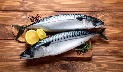 whole mackerel fish on wooden floor with lemon, fresh mackerel fish
