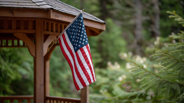 American flag at rustic gazebo in forest clearing