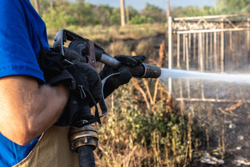 Fireman extinguishing a fire on a field