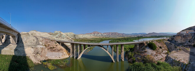 Nallihan Bird Sanctuary Ankara Turkey Panoramic view of a modern arch bridge spanning a river. This panoramic shot showcases a modern arch bridge gracefully crossing a river. Nallıhan Kus Cenneti