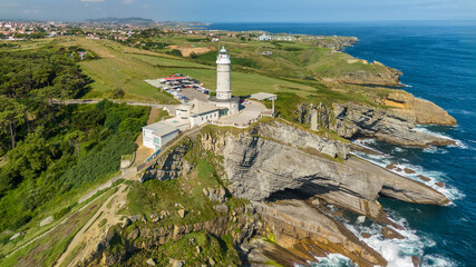 Aerial view of the Cape Mayor lighthouse on the rocky coast in Santander, Spain