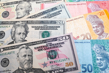 Stack of US Dollar and Malaysian ringgit