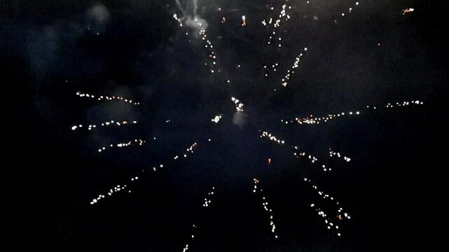 Colorful holiday fireworks bursting in the night sky during a festive celebration