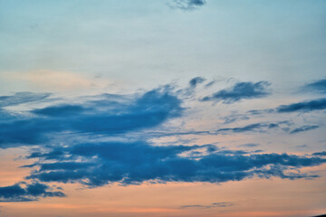 Western sky at sunset. A relaxing scene of day's end with gentle clouds stretching across the...