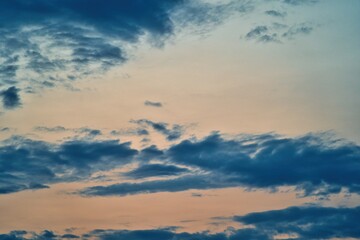 Western sky at sunset. A relaxing scene of day's end with gentle clouds stretching across the...