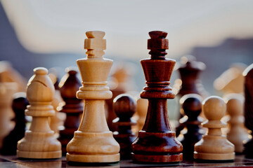 Chess pieces arranged in strategic and symbolic positions. The image can be interpreted through...