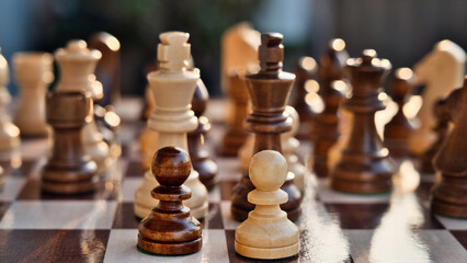 Chess pieces arranged in strategic and symbolic positions. The image can be interpreted through...
