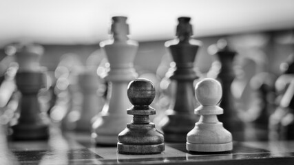 Chess pieces arranged in strategic and symbolic positions. The image can be interpreted through...