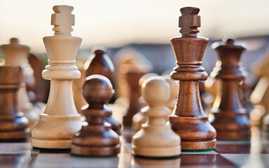 Chess pieces arranged in strategic and symbolic positions. The image can be interpreted through...