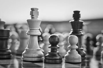 Chess pieces arranged in strategic and symbolic positions. The image can be interpreted through...