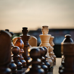 Chess pieces arranged in strategic and symbolic positions. The image can be interpreted through...