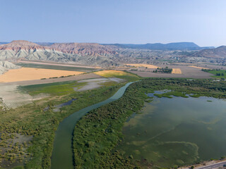 Nallihan Bird Sanctuary Ankara Aerial View of a Winding River Through a Colorful Landscape. A high-angle, expansive shot of a river meandering through a colorful, arid landscape. Nallıhan Kus Cenneti 