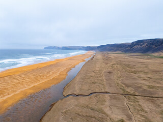 Aerial Drone View of Rauðisandur Golden Beach and Vibrant Blue Waters Flying West Along the Beach— Scenic Coastal Photo