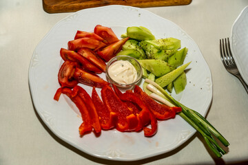 A plate of tomato pepper and cucumber salad
