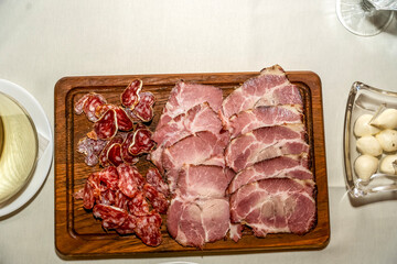 A juicy board with a variety of meats for an elegant appetizer
