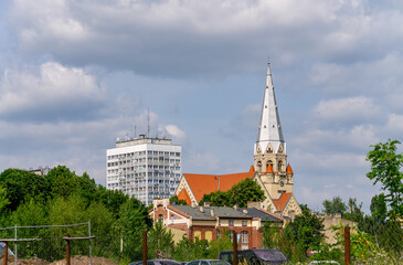 Cityscape of Łódź featuring the historic St. Matthew’s Lutheran Church with its tall spire,...