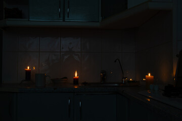 Kitchen by candlelight during power outage - coziness in the dark, candles on the countertop, blackout in the house