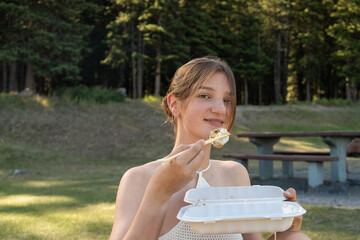 Woman smiling and holding sushi