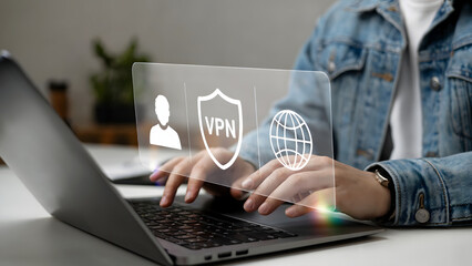 Person securing online connection through VPN on laptop, illustrating digital privacy and secure network access, emphasizing data protection and cybersecurity solutions for remote work.