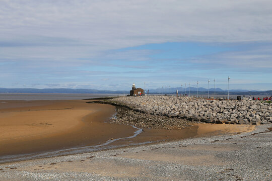 A beautiful morning view of the Morecambe stone jetty with distant views of the hills in the Lake District of Cumbria in England, UK.