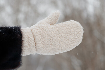 woman hand in white mitt, white snow, winter fun, winter background