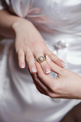 A woman is holding a ring in her hand