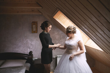 A woman in a black dress is getting ready for a wedding