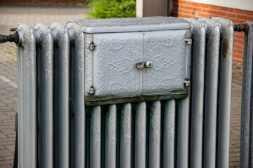 Vintage cast iron appliance with hinged doors for warming food or drying fruits and vegetables, showcasing retro German technology and traditional design for alternative cooking.