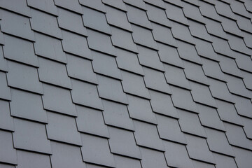 Close-up of a slate tile roof in Germany. Traditional overlapping roofing pattern, used for...