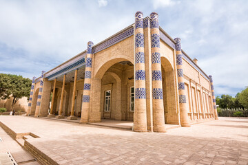 Courtyard and facade of Nurullabay Palace in Khiva, Uzbekistan, showcasing traditional architecture and historic charm.