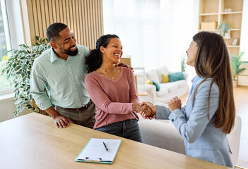 Female Real Estate Agent Selling And Showing The Modern Apartment To His Young Clients couple and shaking hands agreement deal In The Apartment