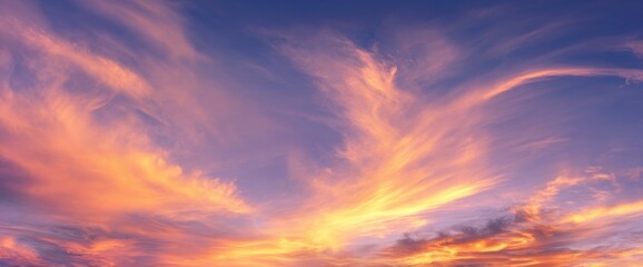 Fototapeta premium Dramatic Sunset Sky Fiery Clouds Painted in Orange, Pink, and Blue Hues Above