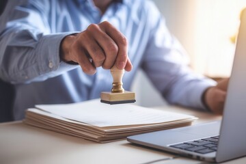Businessman sealing documents with a stamp in the office working environment