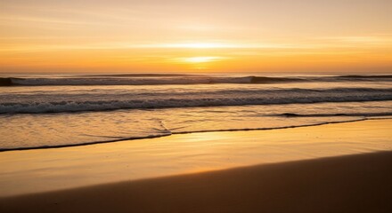 Obraz premium A serene golden sunset reflects on the ocean waves and sandy beach, creating a peaceful and calming scene at the coast, perfect for relaxation and meditation videos