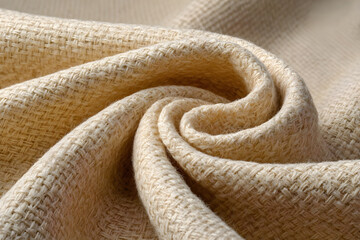 Fototapeta premium Close up of natural woven fabric with a textured surface and soft folds
